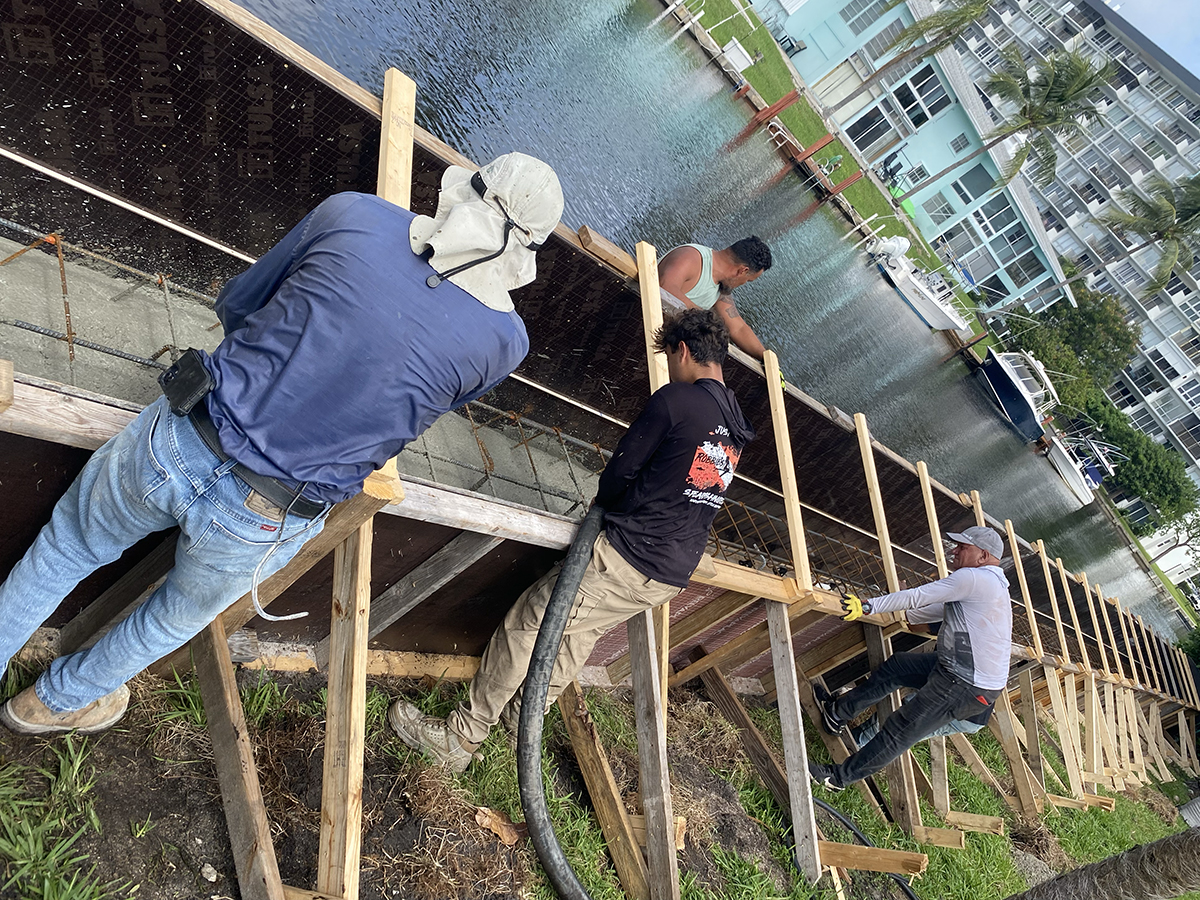 Hydros Marine Construction crew working on a seawall raise project in Pompano Beach, Florida, reinforcing and raising an existing waterfront seawall.